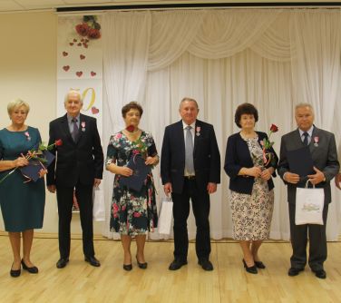 odznaczone małżeństwa pozują do zdjecia z burmistrzem i zastępczynią burmistrza