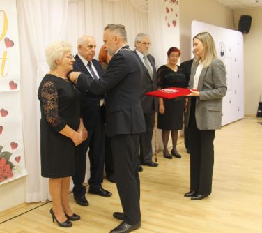 burmistrz miasta wręcza medal kobiecie