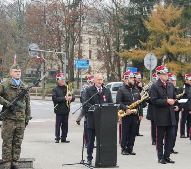 mężczyzna wygłasza przemówienie stojąc przy mównicy