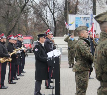 mężczyzna odczytuje apel poległych stojąc przy mównicy