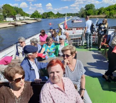 Dzień, na statku. Osoby płyną siedząc na krzesłach