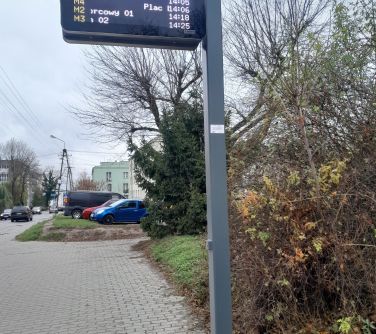 Na dworze, pochmurny dzień. Elektoniczna tablica informacyjna rozkladow jazdy autobusów.